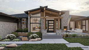 Doorway to property featuring an outdoor fireplace