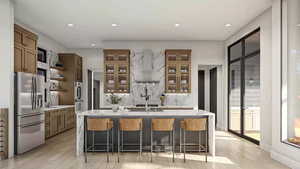 Kitchen with a breakfast bar, light wood-type flooring, wall chimney range hood, and appliances with stainless steel finishes