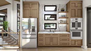 Kitchen featuring sink, double wall oven, light hardwood / wood-style flooring, decorative backsplash, and stainless steel fridge