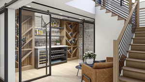 Wine room with hardwood / wood-style floors and a barn door