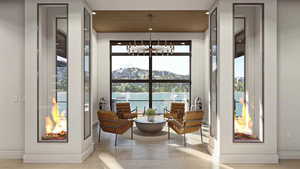 Doorway featuring a notable chandelier, a mountain view, and light wood-type flooring