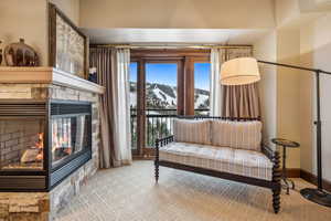 Sitting room with a mountain view and carpet floors