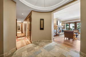 Hall with ornamental molding and light wood-type flooring