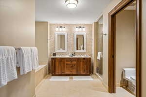 Bathroom with tile patterned floors, vanity, an enclosed shower, and toilet