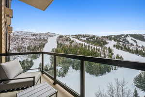 Snow covered back of property with a mountain view