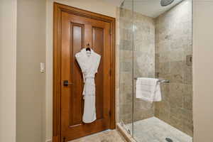 Bathroom featuring a shower with door