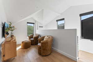 Sitting room featuring vaulted ceiling and light hardwood / wood-style flooring