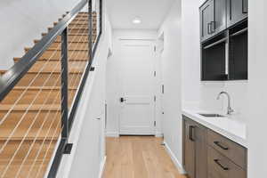 Interior space with hardwood / wood-style flooring and sink