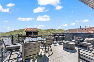 View of patio / terrace featuring a mountain view and a balcony