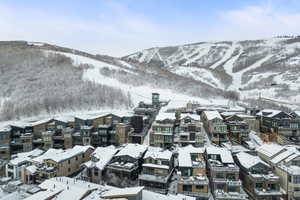 Snowy aerial view featuring a mountain view