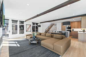 Living room featuring beam ceiling and light hardwood / wood-style floors