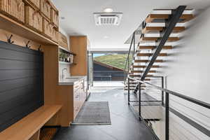 Mudroom featuring sink and light tile patterned floors