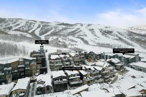 Snowy aerial view featuring a mountain view