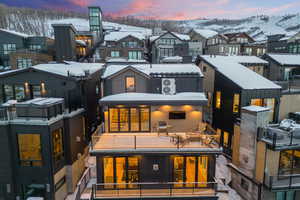 Snow covered house featuring a balcony