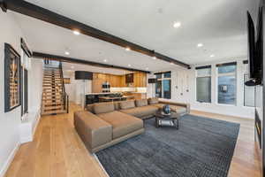 Living room featuring beam ceiling and light hardwood / wood-style floors