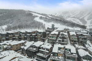 Snowy aerial view featuring a mountain view