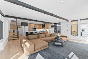 Living room featuring light hardwood / wood-style flooring and beamed ceiling