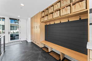 Mudroom featuring wood walls