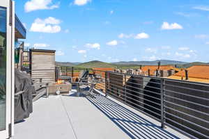 View of patio featuring a mountain view and a balcony