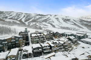 Snowy aerial view featuring a mountain view