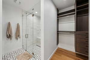 Bathroom featuring wood-type flooring and walk in shower