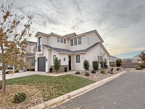 View of front of house with a front yard and a garage