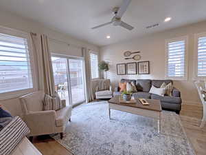 Living room featuring light hardwood / wood-style flooring and ceiling fan