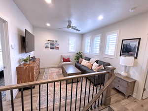 Living room featuring light hardwood / wood-style floors and ceiling fan