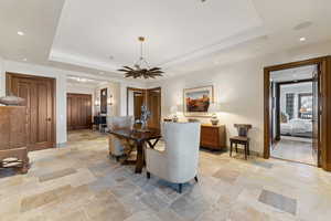 Dining space featuring a chandelier and a tray ceiling