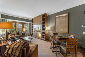 Living room with light carpet and crown molding