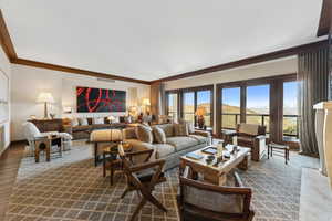 Living room featuring crown molding and dark wood-type flooring