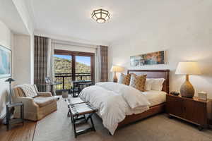 Bedroom with access to exterior and wood-type flooring