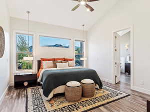 Bedroom featuring wood-type flooring, multiple windows, and ceiling fan