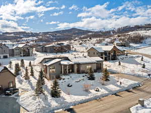 Snowy aerial view featuring a mountain view