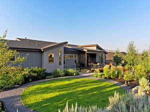 View of front of house with a deck and a front lawn