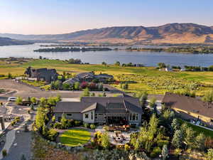 Aerial view at dusk featuring a water and mountain view