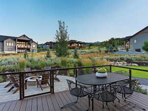 Wooden deck with a patio area and an outdoor fire pit