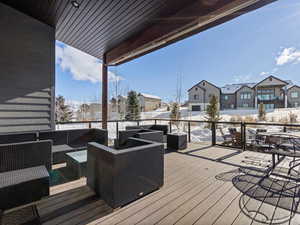 Snow covered deck featuring outdoor lounge area