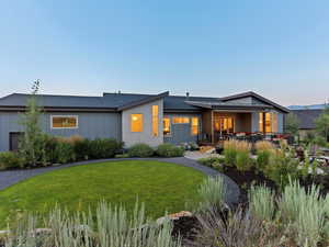 Rear view of property featuring a patio area and a yard