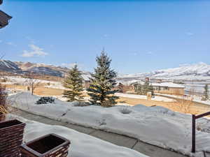 Snowy yard featuring a mountain view