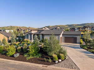 View of front of home featuring a mountain view and a garage