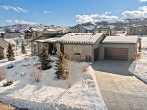 View of front of house with a mountain view and a garage