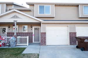 Multi unit property featuring covered porch and a garage