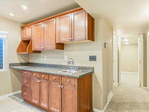 Kitchen with sink and light colored carpet