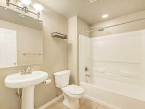 Full bathroom featuring tile patterned flooring, shower / bathtub combination, toilet, and sink