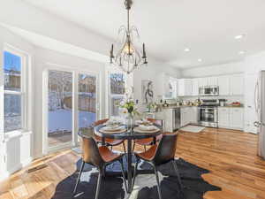 Dining area featuring light hardwood / wood-style flooring, a chandelier, and sink