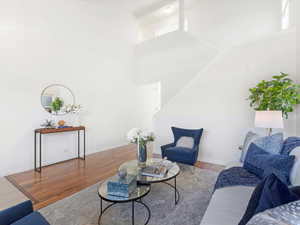 Living room featuring a high ceiling and hardwood / wood-style flooring