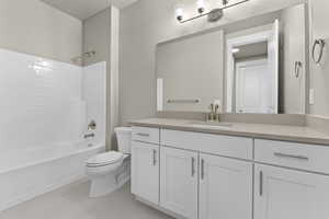 Full bathroom featuring vanity, toilet, and  shower combination