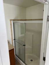 Bathroom with vanity and an enclosed shower