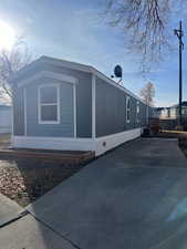 View of side of home featuring central AC